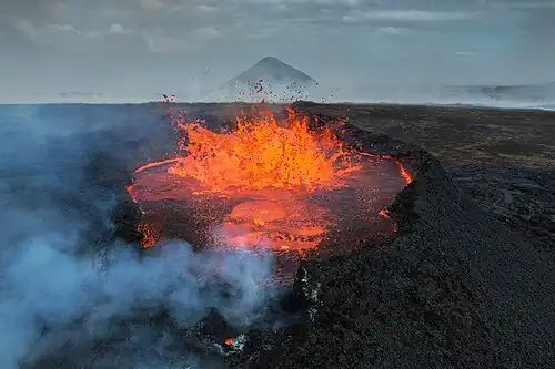 Volcano eruption at Fagradalsfjall next to Litli-Hrútur and with Keilir in the background