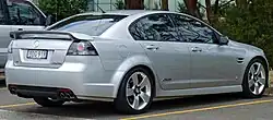 Rear-three-quarters view of a silver-coloured sedan