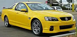 Front-three-quarters view of a yellow coupe utility