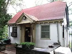 The cottage, a one-story structure with a red roof