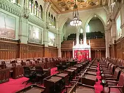 The Senate, also divided into opposing ranks of desks, with red decor