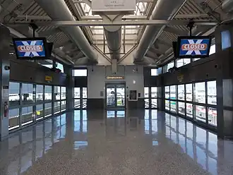 Interior of Terminal 5 station. There are platform screen doors on either side of the platform, and there is a skylight on the ceiling.