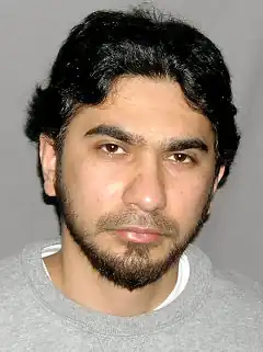 Headshot of Shahzad on a gray background