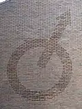 Stylized Mars symbol. The spear partly crosses the shield.