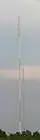 An antenna tower stands 446 feet (136&nbsp;m) tall in Springfield, MO with its red and white aircraft warning paint visible