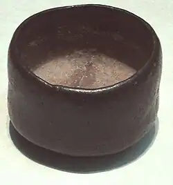Black raku ware tea bowl with rough texture