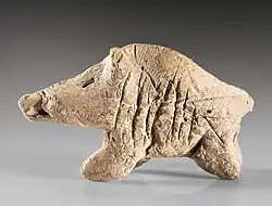 A clay boar figurine from the Neolithic period, found at Tepe Sarab.
