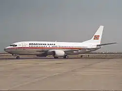 Boeing 737-400 with a white body, metallic belly and a red cheatline