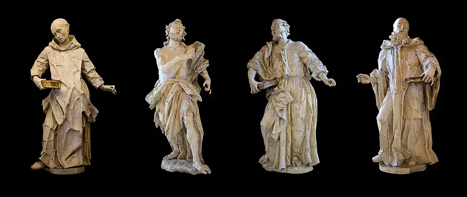 Photographs of four stone statues representing four men in various postures.