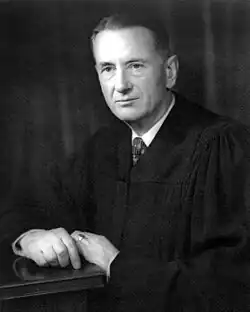 Black-and-white picture of Charles Whittaker in formal attire with a serious look