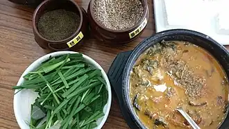 Chueo-tang (loach soup) served with garlic chives