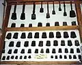 A display of cow bells (and sheep bells in bottom row) formerly used by Appalachian farmers, collected by John Rice Irwin. Photo taken at the Museum of Appalachia in Norris, Tennessee, United States.