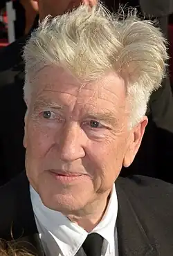 Man in jacket with white hair