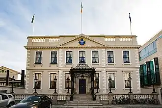 Image of building facade and associated car park.