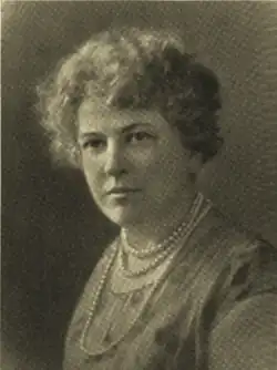 B&W portrait photo of a middle-aged woman with curly short hair