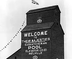 Grain elevator in Melville decorated for the visit of King George VI and Queen Elizabeth in May, 1939