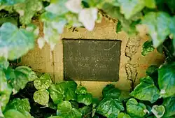 Memorial plaque on a wall commemorating Helmut Newton