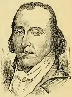 A man with dark, receding hair wearing a high collared white shirt and black jacket