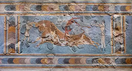 Fresco of an acrobat straddling a bull, with two helpers