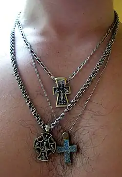 A man with three different cross necklaces