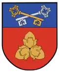 A coat of arms depicting a golden key overlapping a silver key on a blue background at the top and three golden nuts on a red background on the bottom