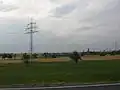 A 110 kV-line with two communication cables fixed like garlands on grounded ropes on a half of the lowest crossbar