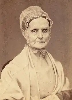 Photograph of Lucretia Mott wearing a pale bonnet and shawl and facing the camera.