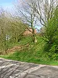 The remains of the wooden pedestrian footbridge and way up to Lugton High station.