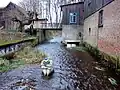 Water mill at Lutter in Marwede (part of Scharnhorst) with the stone sculpture Die Heide aus Lüneburg