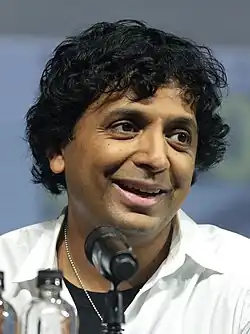 Shyamalan smiling