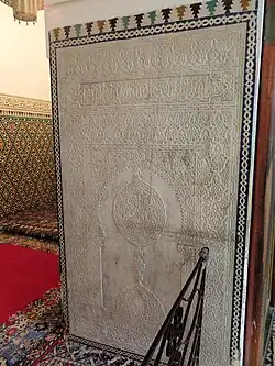 Saadian-era carved marble panel at the entrance to the tomb chamber