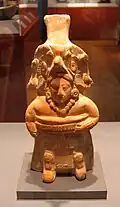 The yoke and kneepads identify this molded ceramic Maya figurine as a ballplayer. Like many of these Jaina Island style figurines, it also functions as a whistle. 600–900 CE.