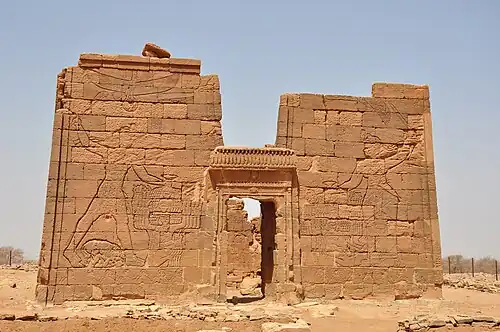 Pylons depicting King Natakamani and Queen Amanitore smiting enemies. The queen holds a sword, the king an axe. Apademak Temple in Naqa.[5]