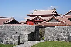 A view of Shuri castle, ornate with elements of Chinese architecture, from behind its front wall