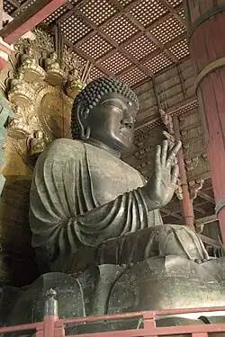 A large Buddha statue in a temple interior