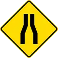 Road narrows on both sides
