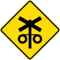 Controlled railway crossing ahead with signals and gates
