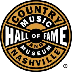 The logo of the Country Music Hall of Fame and Museum. It is features black and yellow stripes with a circular design.