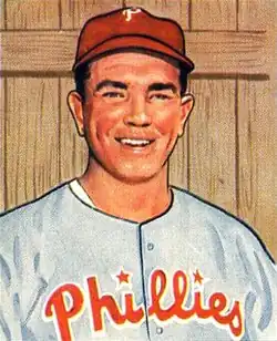A baseball card image of a smiling man wearing a red baseball cap and a gray baseball jersey with "Phillies" across the chest in red script