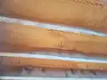 Polyurethane foam used as joist cavity insulation at a restaurant near Philadelphia, not in direct sunlight, exhibiting shrinkage at the bond interface.