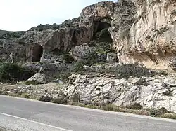 Raised beach 2&nbsp;km west of Paleochora (Crete) showing wave-cut notch and sea caves uplifted by about 9 m during the earthquake