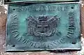A stamped brass Italian fire plaque
