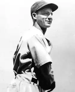 A man in a light jersey and dark cap