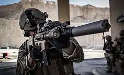 Belgian SFG soldier armed with a SCAR-L with a suppressor