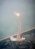 Launch of Atlantis viewed through the window of a Shuttle Training Aircraft.
