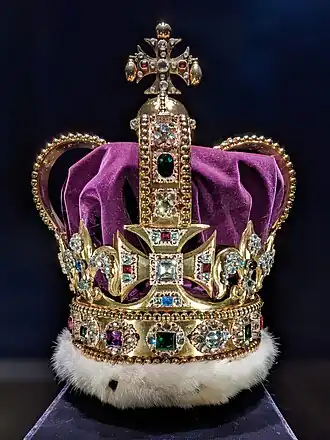 Large gold crown decorated with diamonds and red, green, blue, and purple gemstones