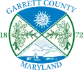 A rounded rectangle seal with blue-and-green quadrants depicting natural scenes