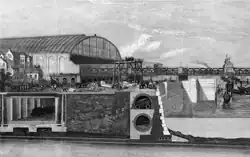In this drawing the railway is shown on the left, underground in a rectangular tunnel. On the right is the Thames and between them is a wall and earth.