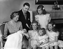 Family photo of a couple with four girls and a baby