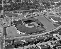 A black and white aerial view of Sick's Stadium and the surrounding cityscape